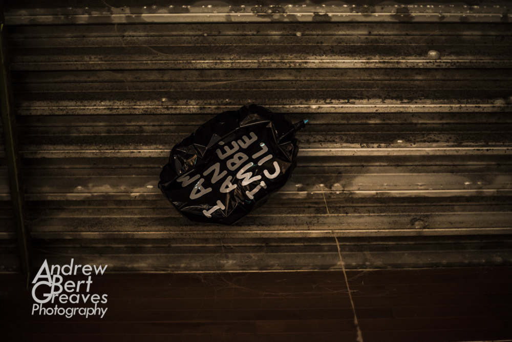 an I am an imbecile balloon stuck on the inside of a corrugated roof