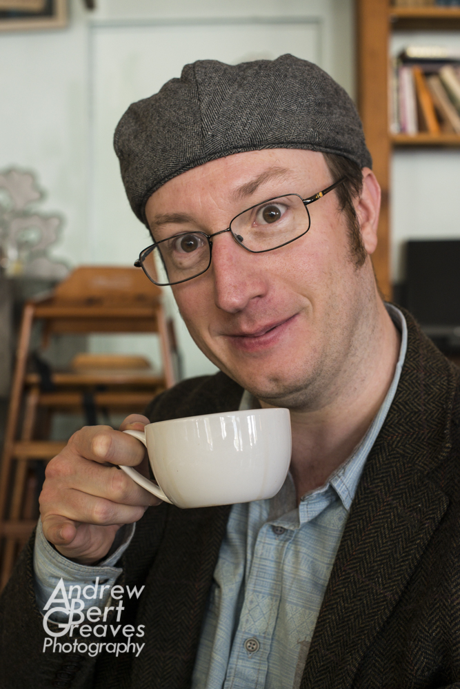 Phil Cooper drinking tea with his little finger sticking out