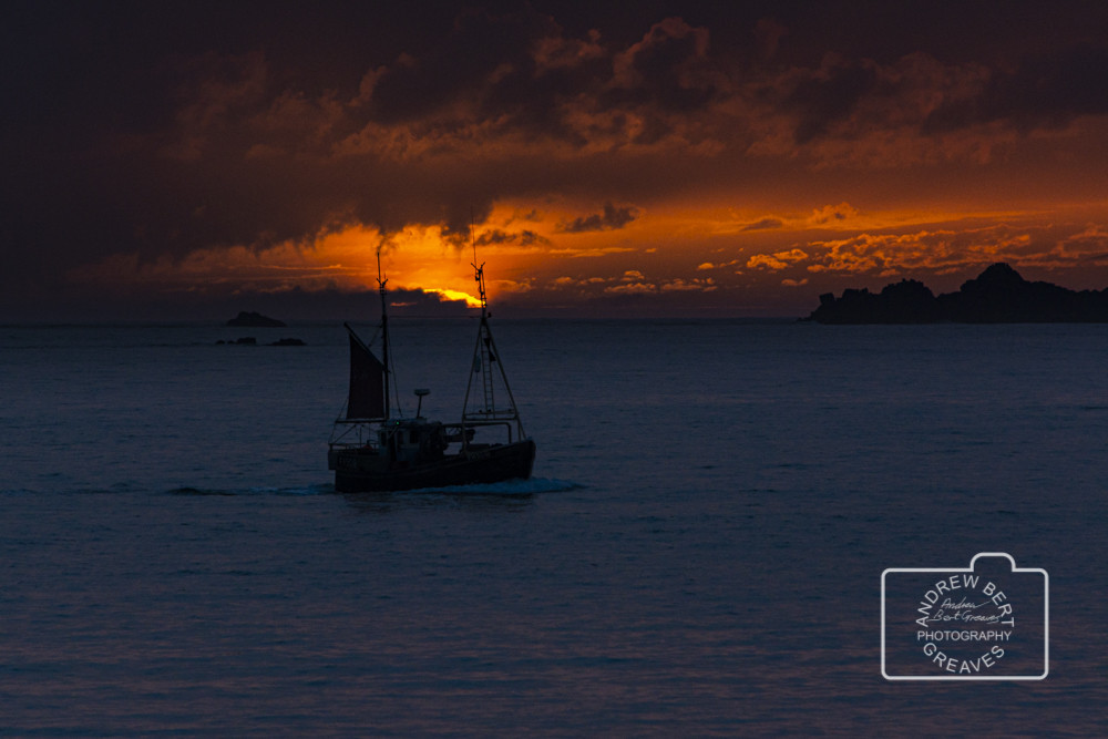 Boat sailing at sunset off St Mary's, Isles of Scilly Boat sailing at sunset off St Mary's, Isles of Scilly